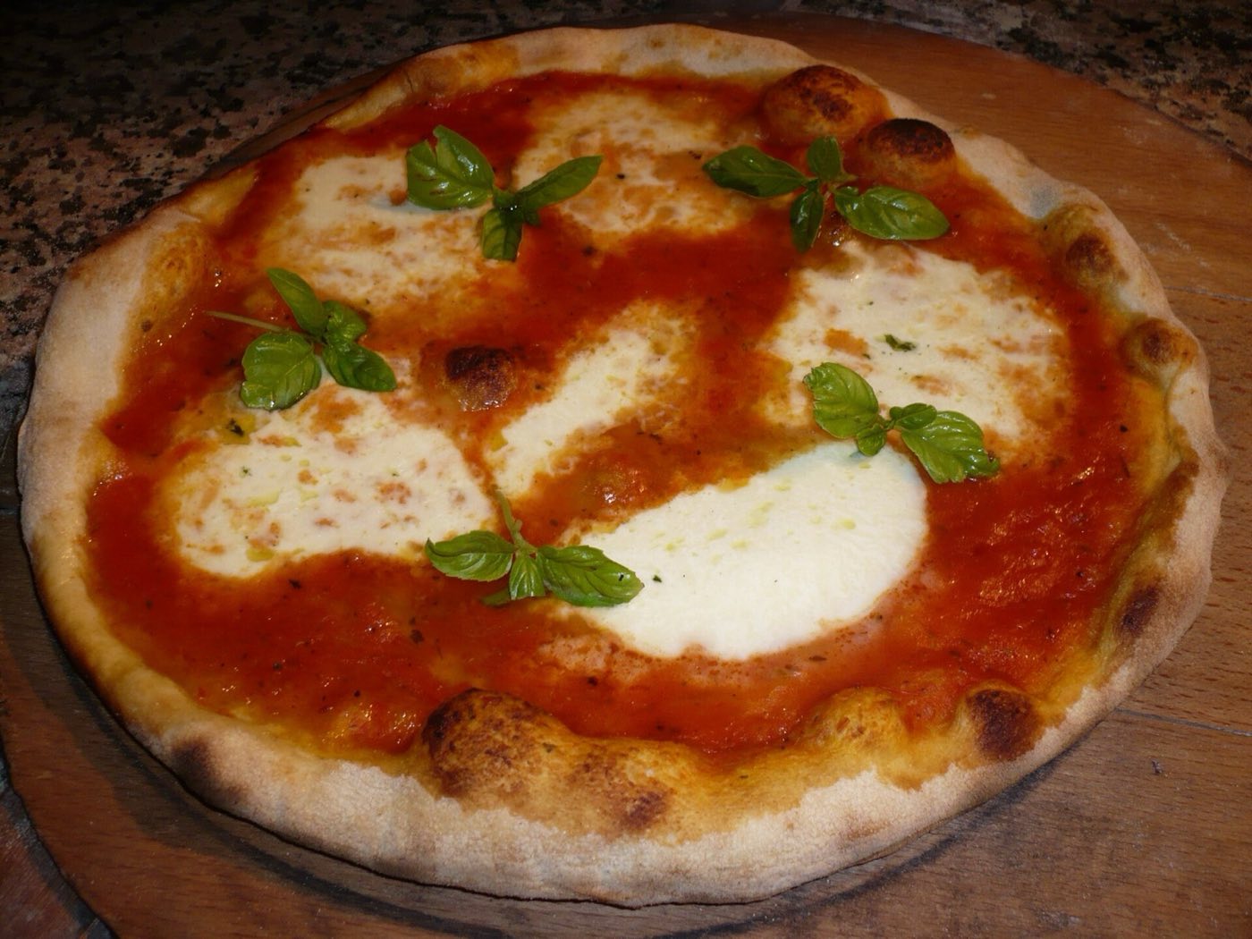 Authentic Neapolitan pizza margherita fresh from a wood-fired oven in Naples